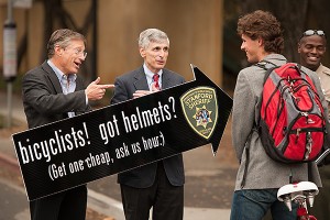 Provost John Etchemendy and Medical School Dean Philip Pizzo play good-cop, good-cop with helmetless rider Gregory Manker, a sophomore. The Stanford Sherrifs were running an information campaign on the corner of Lomita Drive and Santa Teresa Street with the able help of the administrators.